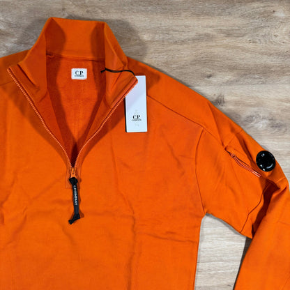 C.P. Company Diagonal Raised Half-Zip Lens Sweatshirt in Russet Orange